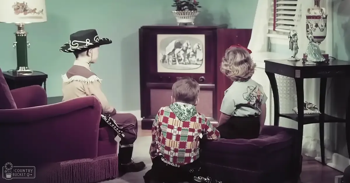 A family scene in a living room setting with adults and children, furniture, and decor.