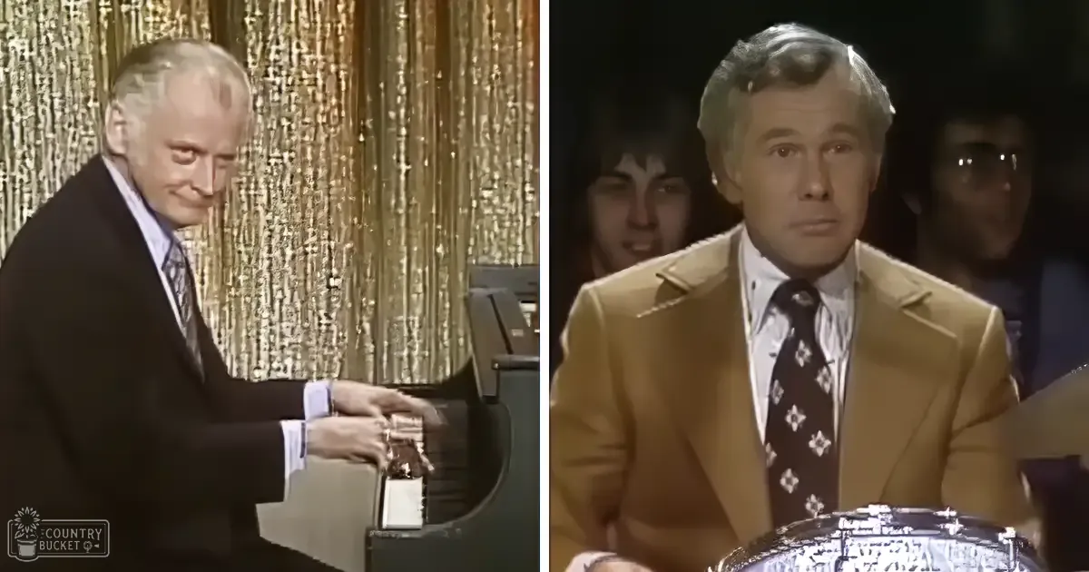 Older adult male singer playing piano with another man seated nearby in a dimly lit indoor setting