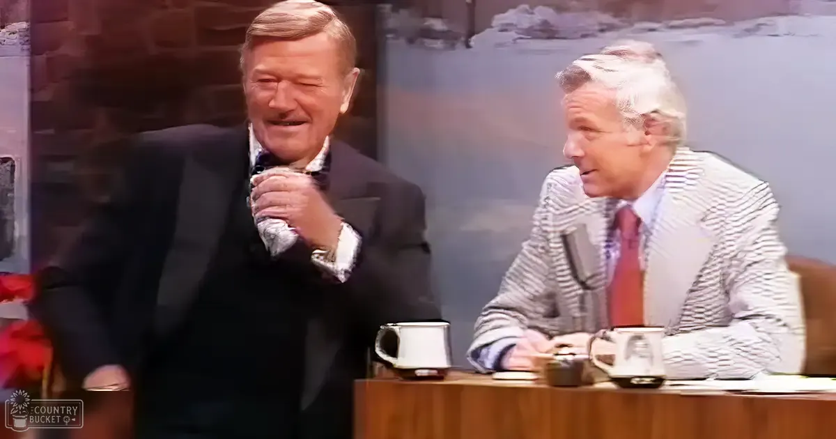 Talk show set in an indoor studio with two older adult males, classic talk show furniture, and a painted landscape backdrop.