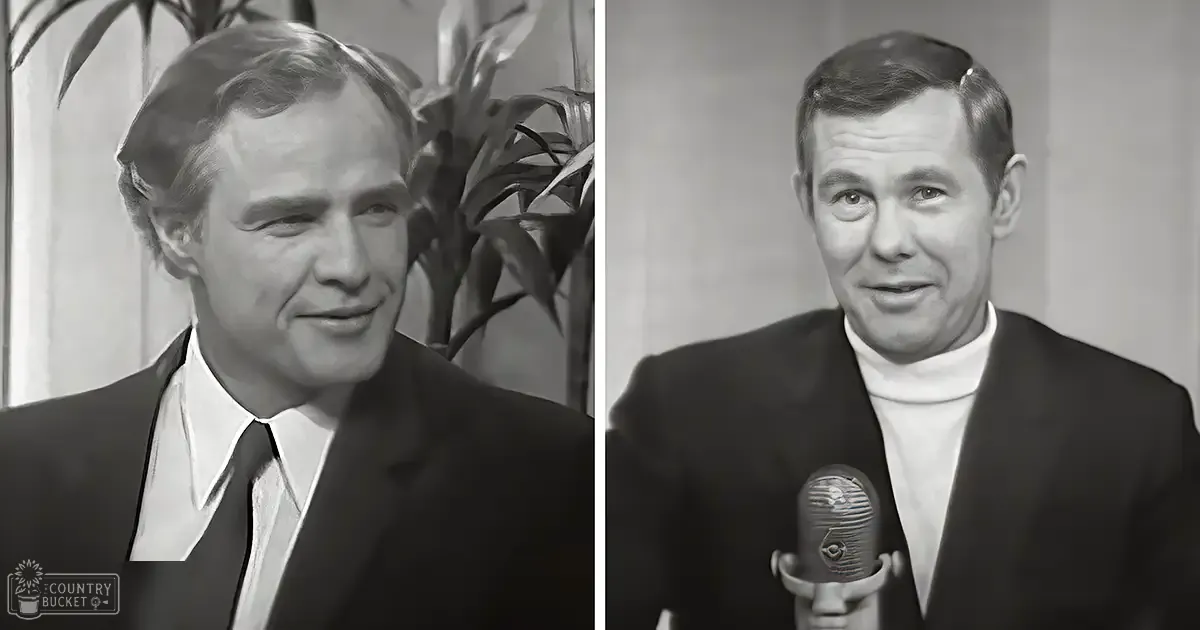 Middle-aged men wearing formal suits indoors; one holding a vintage-style microphone.