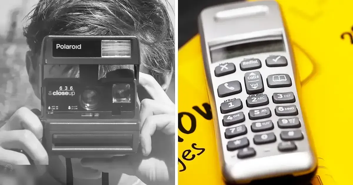 A modern mobile phone with keypad held beside a Polaroid camera labeled '636 closeup' by someone wearing a dark, thick top or jacket in an indoor setting.