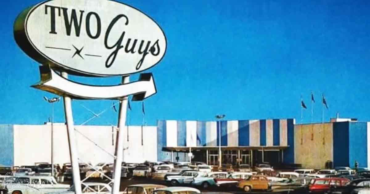 Two Guys diner signage with vintage cars in parking lot, mid-20th century setting, clear blue sky, daytime fair weather.