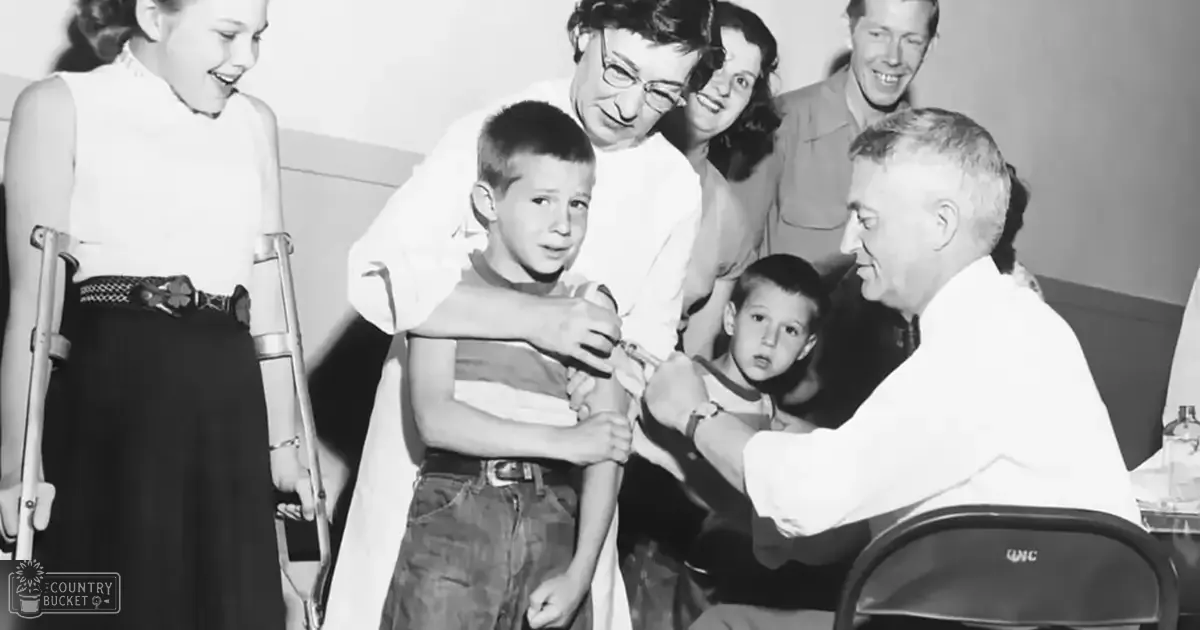 A young boy receiving an injection from a doctor in what appears to be a mid-20th century medical office setting with various people and objects present.