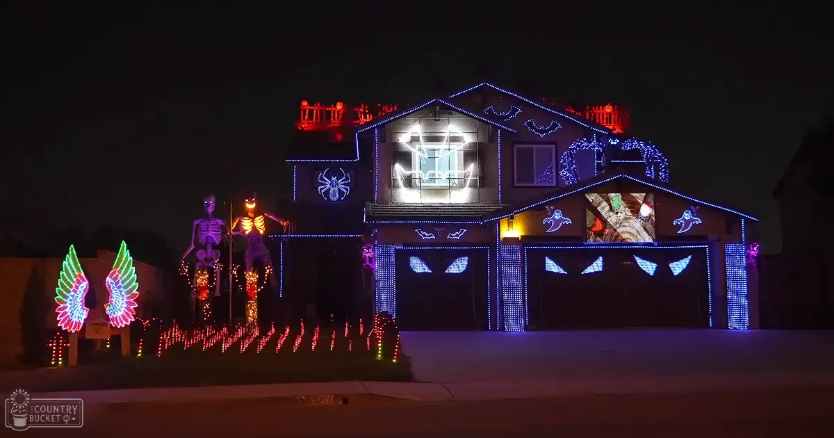 A Halloween-themed urban residential house decorated with spooky symbols, glowing lights, and festive atmosphere during nighttime or early evening.