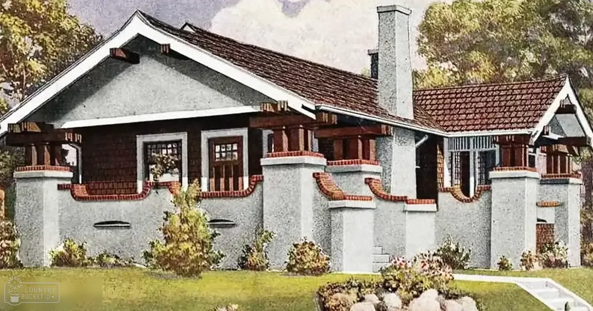 An outdoor residential setting with a house with brick accents around windows and doors, surrounded by shrubs and small bushes under clear daylight conditions.