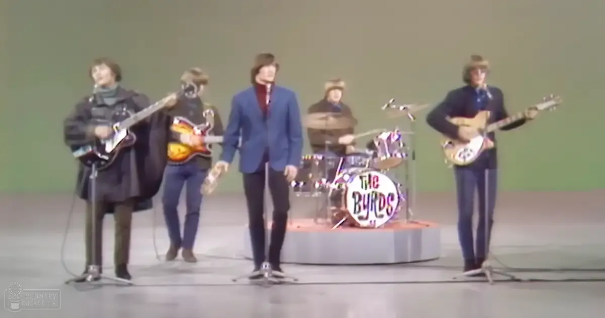 A musical performance by 'The Byrds' in a studio setting with young adult males wearing dark and blue garments.