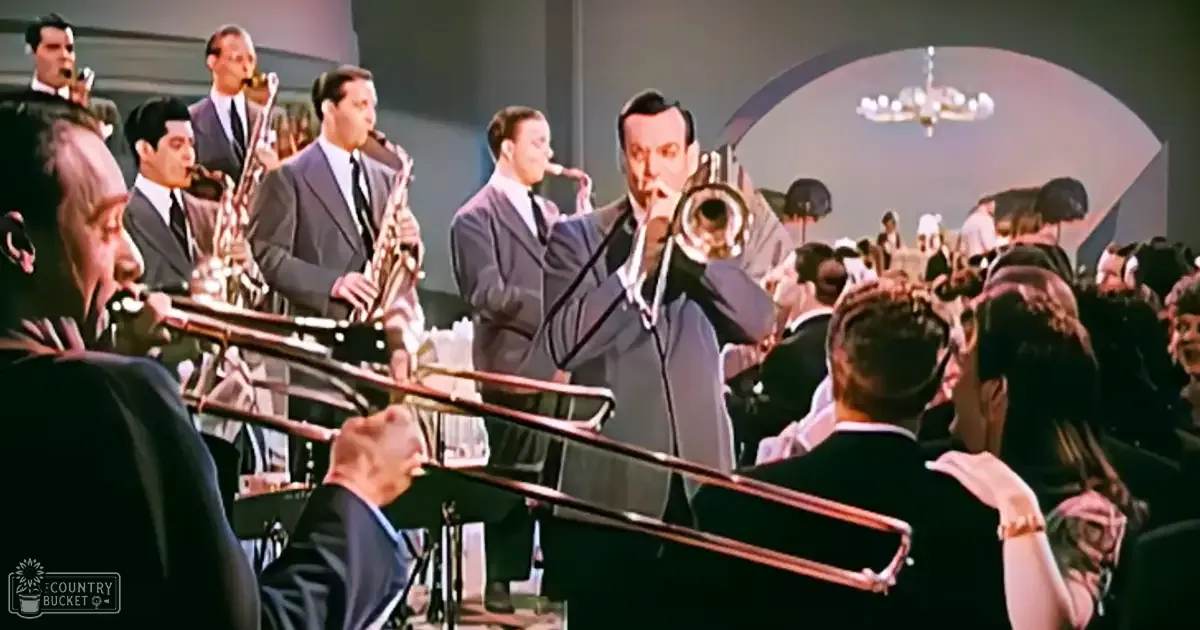 A jazz band performing indoors in a formal setting with mid-20th-century attire, surrounded by an audience seated at tables under artificial lighting.