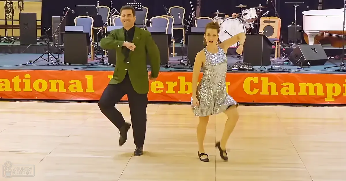 A dance performance at the National [Partially Obscured] Championship event indoors with young male and female dancers on stage.