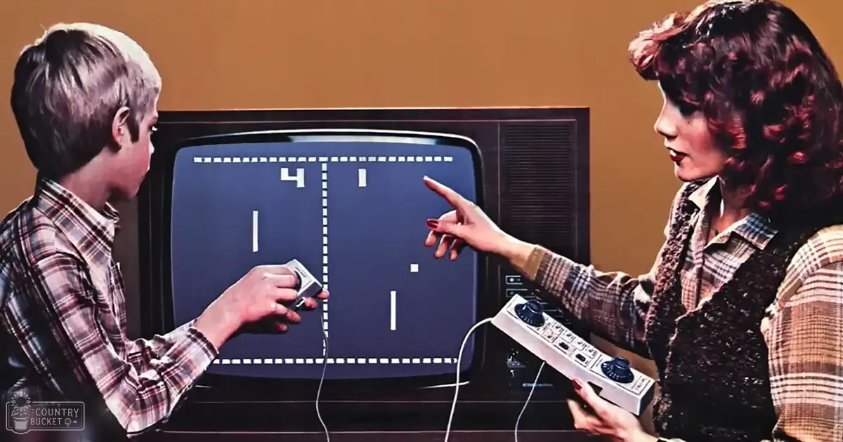 A young adult male in a late 1970s plaid shirt stands beside an adult female holding a vintage game controller, both in front of a television displaying early video game graphics.