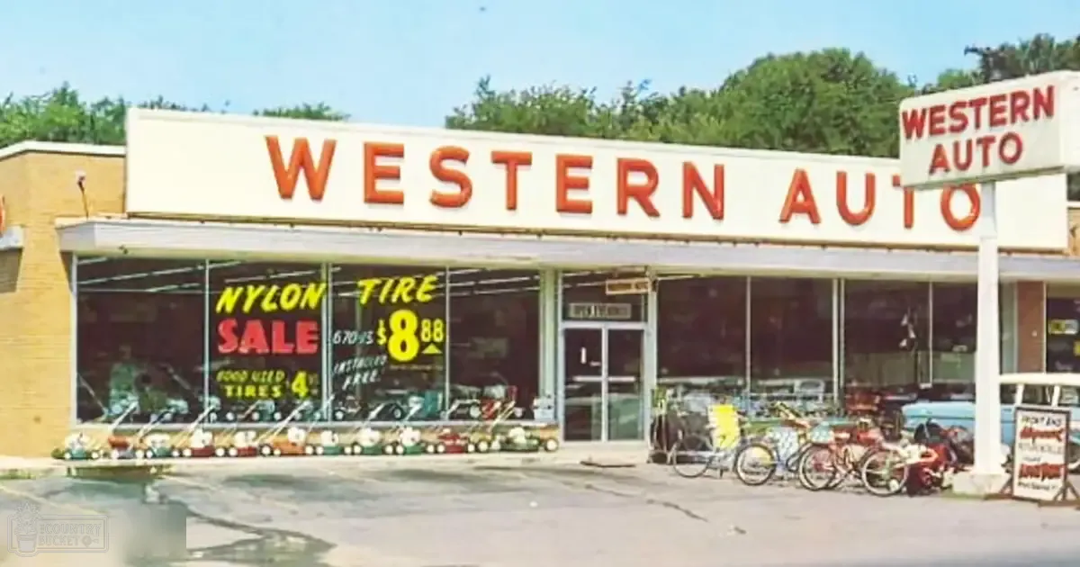 Western Auto store with lawn mowers and bicycles in an urban area during daytime.