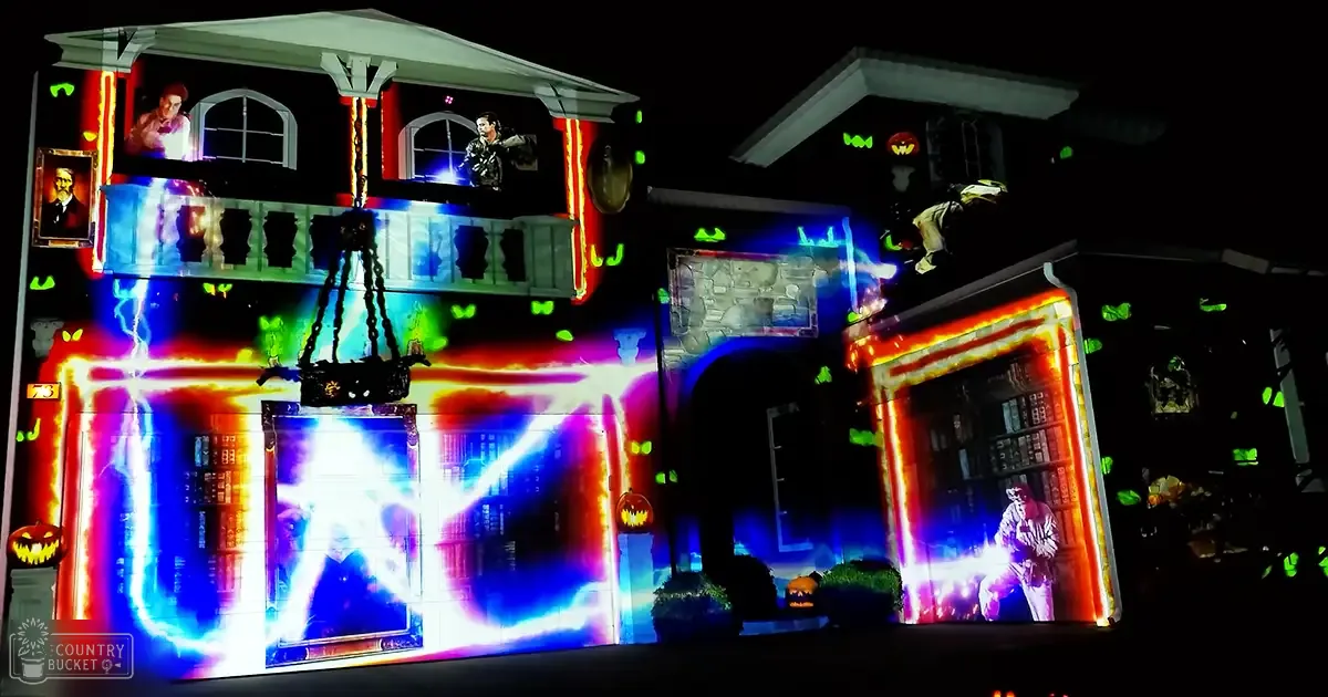 Halloween-themed house projection display with dynamic lighting effects and spooky symbols at night in a residential neighborhood.