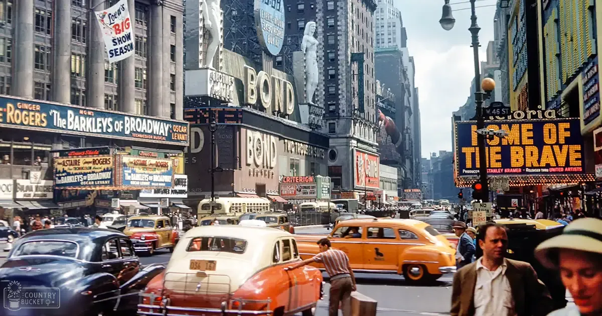 A bustling urban street scene in New York City during the mid-20th century, with vintage cars and buildings with iconic billboards for Broadway shows like "The Barkleys of Broadway" and "Home of the Brave," crowded with pedestrians and vehicles, showcasing a vibrant palette dominated by reds, yellows, blues, and greys.