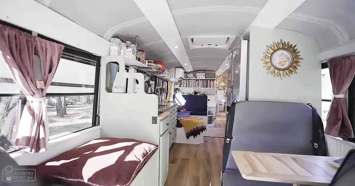 Compact, well-organized interior space of an RV or camper van in a residential area with natural light.