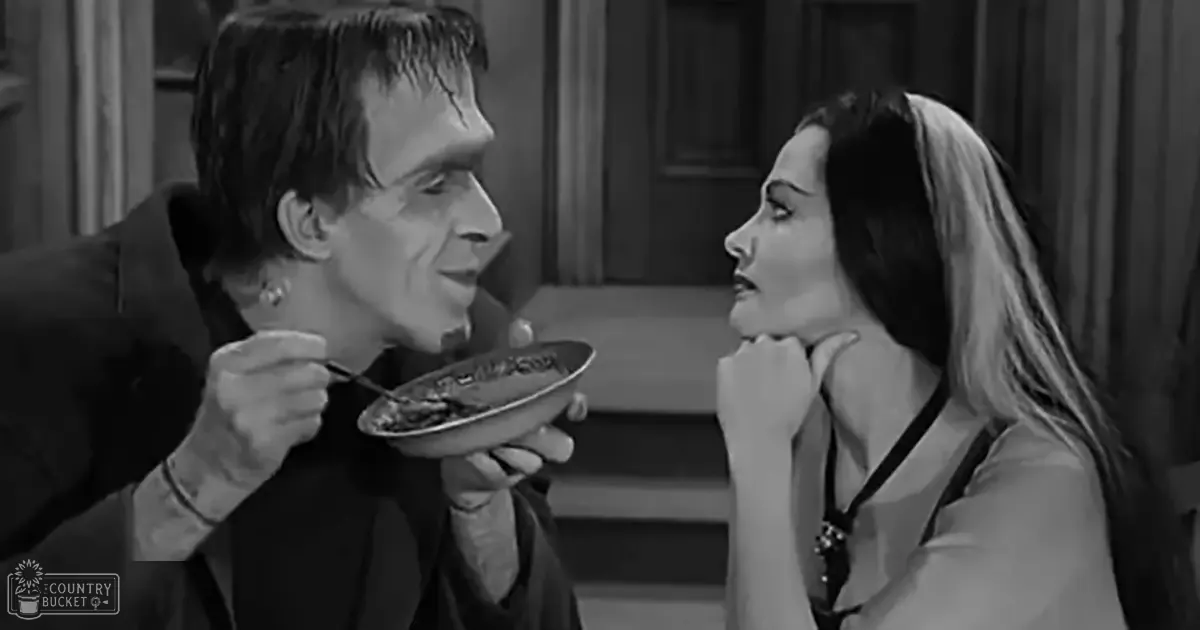 A man in a dark suit holds food over his mouth, interacting with another person in a classic horror film setting.