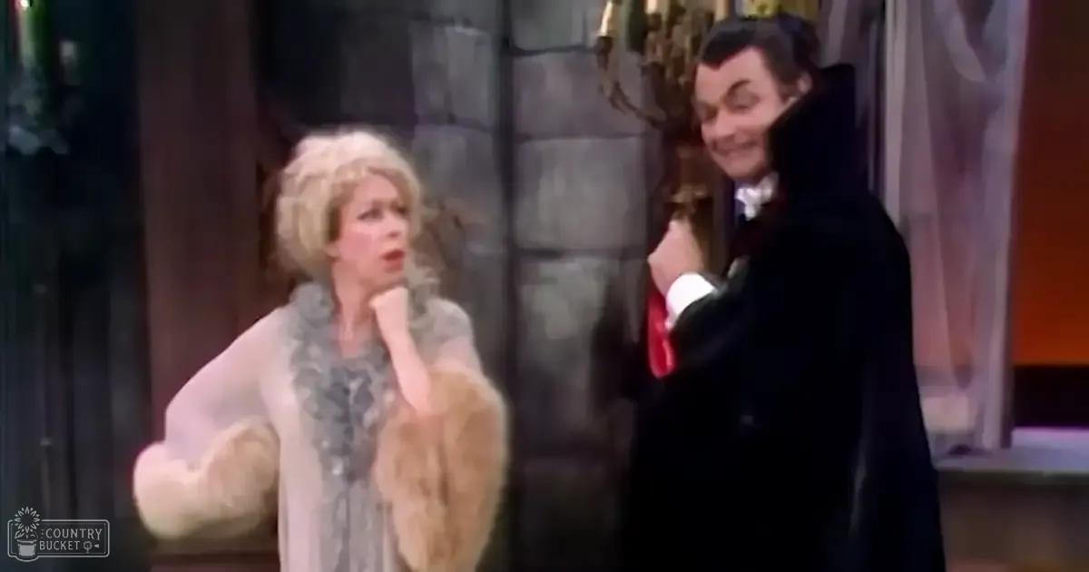 A theatrical performance scene with middle-aged actors dressed in vintage-style costumes, set against a stone wall and ornate curtains.