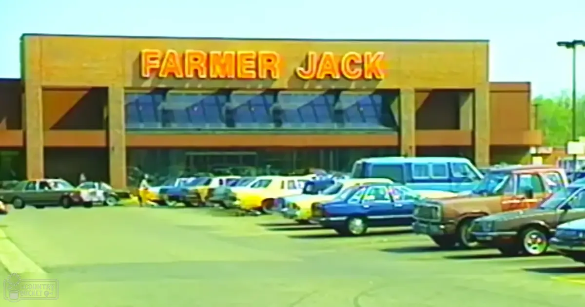 Farmer Jack store in outdoor parking lot, vintage cars, daytime spring or summer scene.