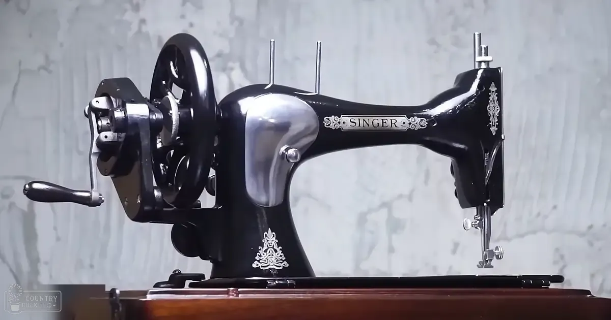 A vintage Singer sewing machine with ornate detailing on its body sits atop a wooden surface in an indoor setting.