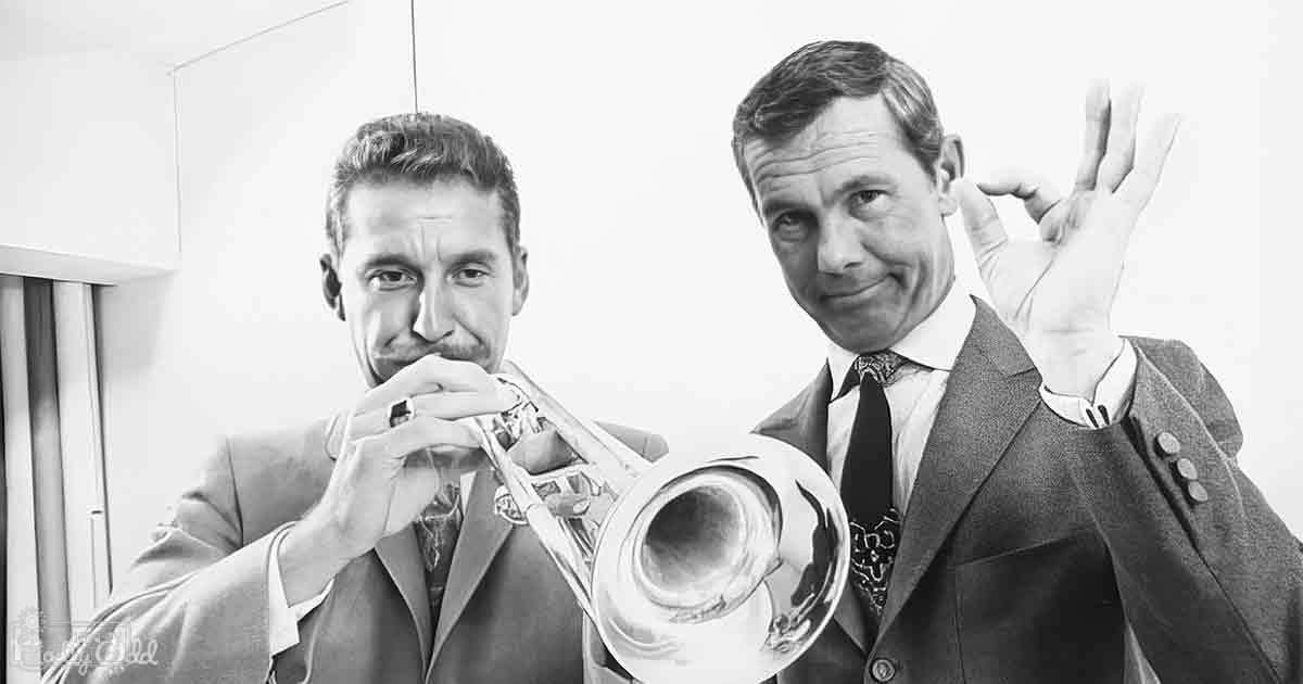 A mid-20th-century musical performance scene with two adult males dressed in suits, possibly recording music indoors under even lighting.