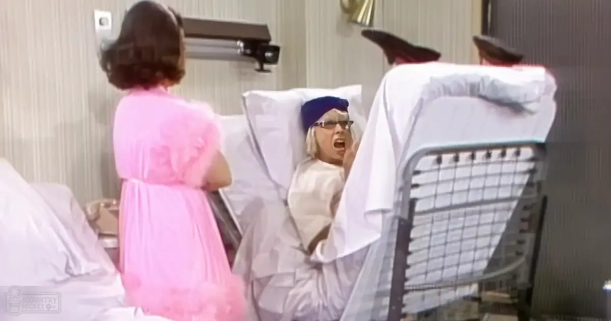 An older female patient lies distressed on a hospital bed, surrounded by a mid-20th century medical setting with striped wallpaper and checkered furniture.