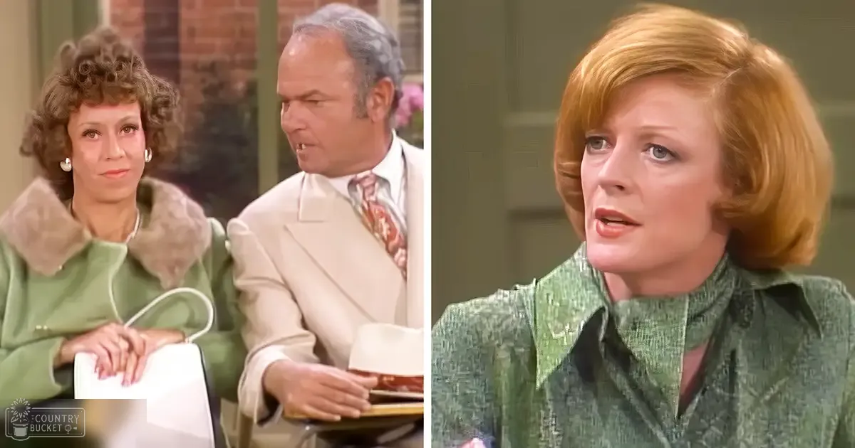 An adult female with curly brown hair wearing a green dress with a fur collar, holding a white handbag, stands next to an adult male in a light-colored suit jacket and patterned tie. The scene appears to be from a dialogue-driven moment indoors.