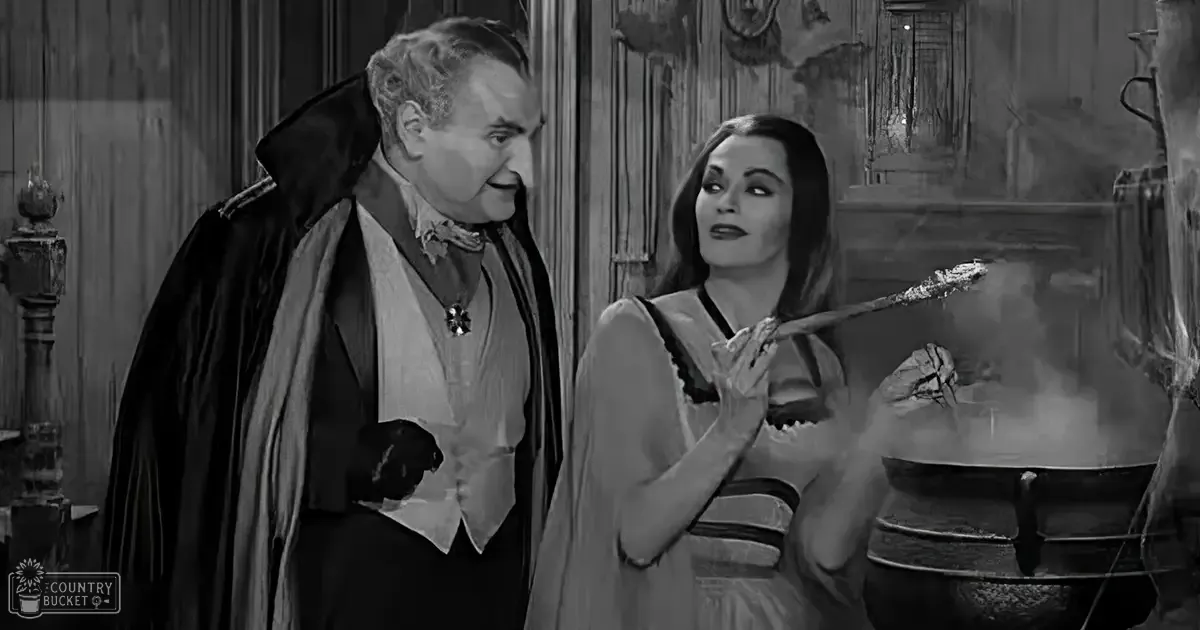 A dimly lit, gothic interior with an older adult male singer wearing a dark coat and a young adult female in a light-colored dress, a large cauldron emitting steam is prominently featured on the right.