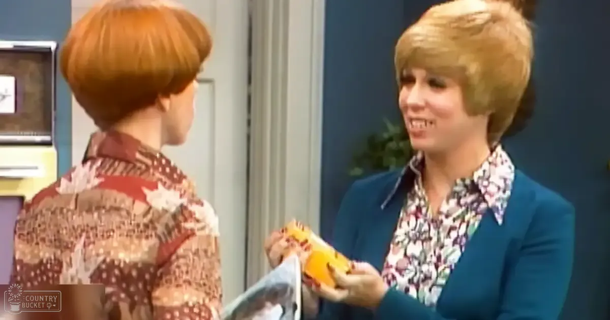 Two women in a mid-20th century-inspired setting with floral blouses and a teal blazer, holding what looks like a banana or toy.