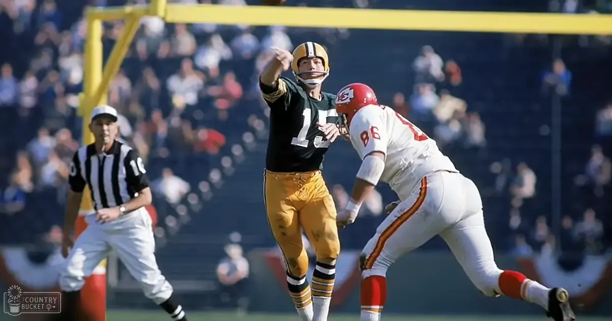 Adult male football players in action during a game at an outdoor stadium with spectators and yellow goalpost.
