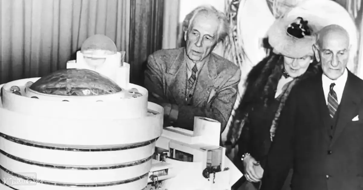 A model of the Guggenheim Museum displayed on a table with people around it; indoors, possibly in an event or presentation room.