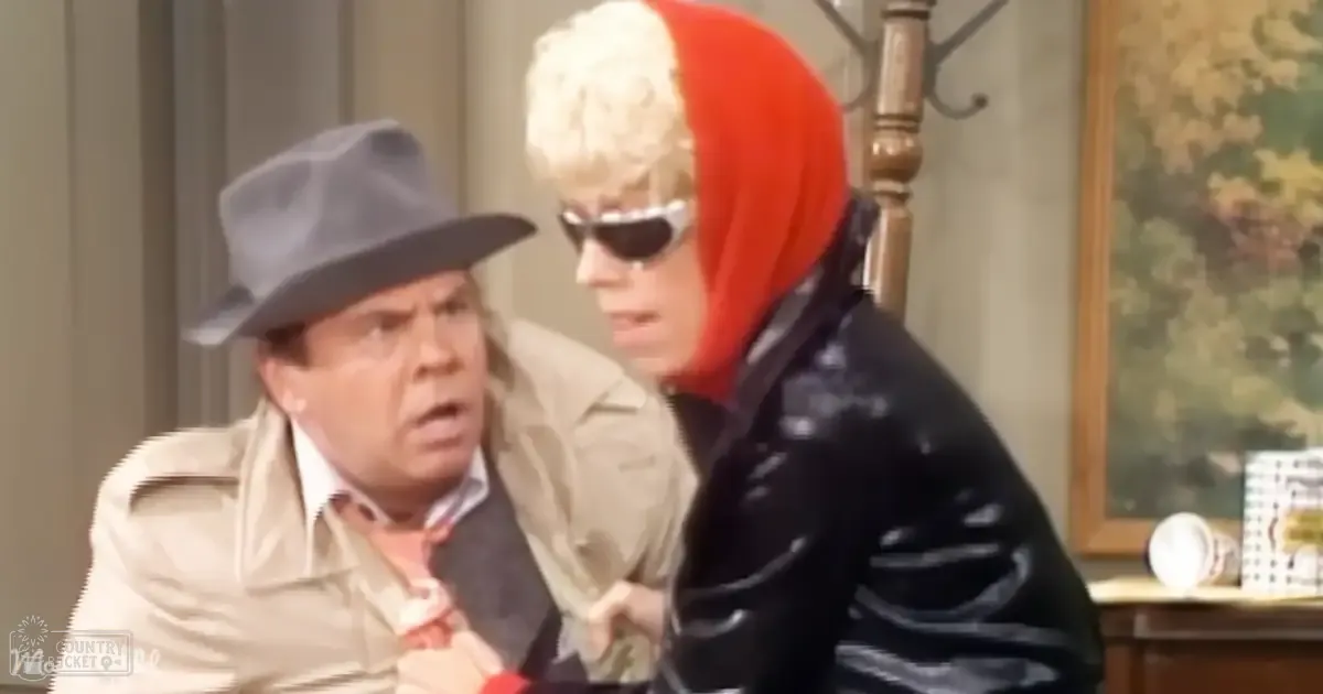 A comedic scene with two older adults in a domestic setting, one wearing a beige trench coat and the other in a black leather jacket with red accents.