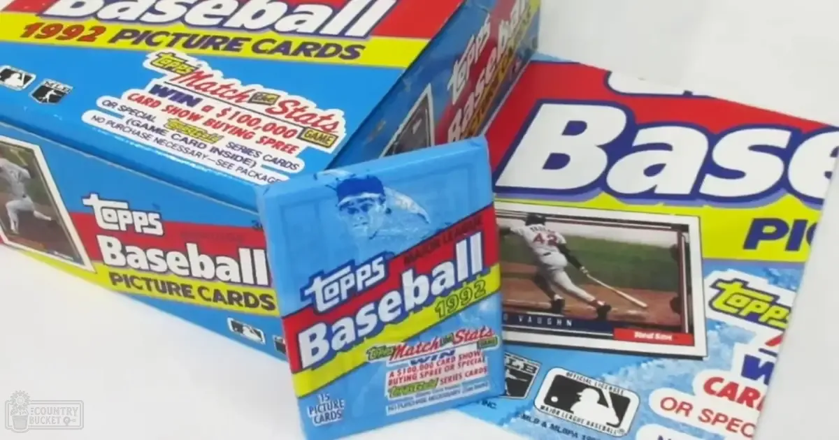 Three boxes of Topps Baseball 1992 Picture Cards with a predominantly blue design with red and yellow accents and an image of a baseball player in action on one box, indoors setting.