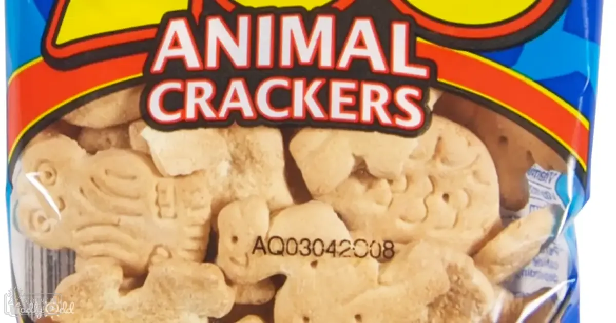 A close-up shot of a bag labeled 'Animal Crackers' with visible product code AQ03042008 and partial nutritional details, set indoors on a surface.