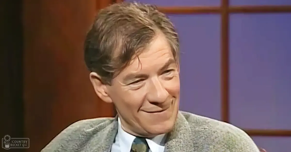 Middle-aged man in a tailored blazer with textured pattern, mid-20th century style, indoors studio setting with wooden paneling and soft lighting.