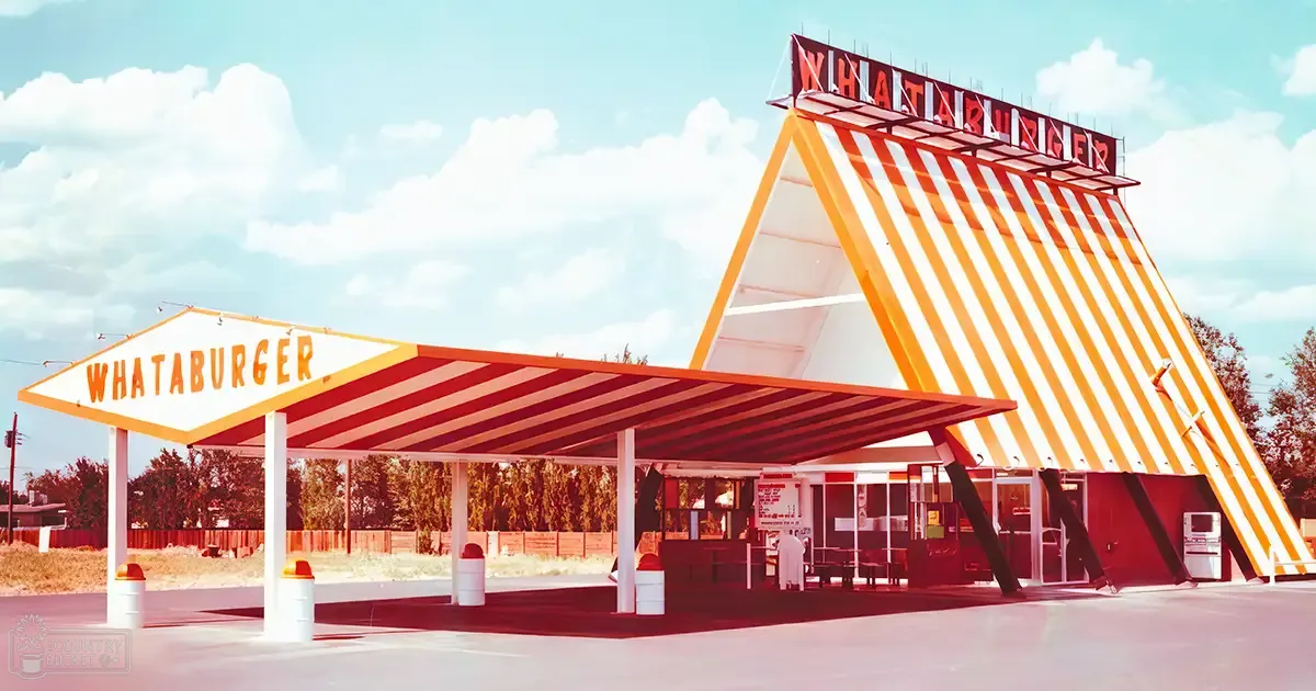 Whataburger restaurant with iconic triangular roof in an outdoor setting with clear skies and bright sunlight.
