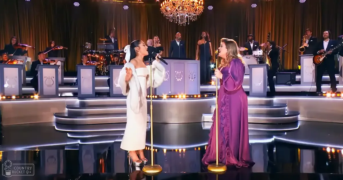 A musical performance scene at an indoor stage with a chandelier above the performers.