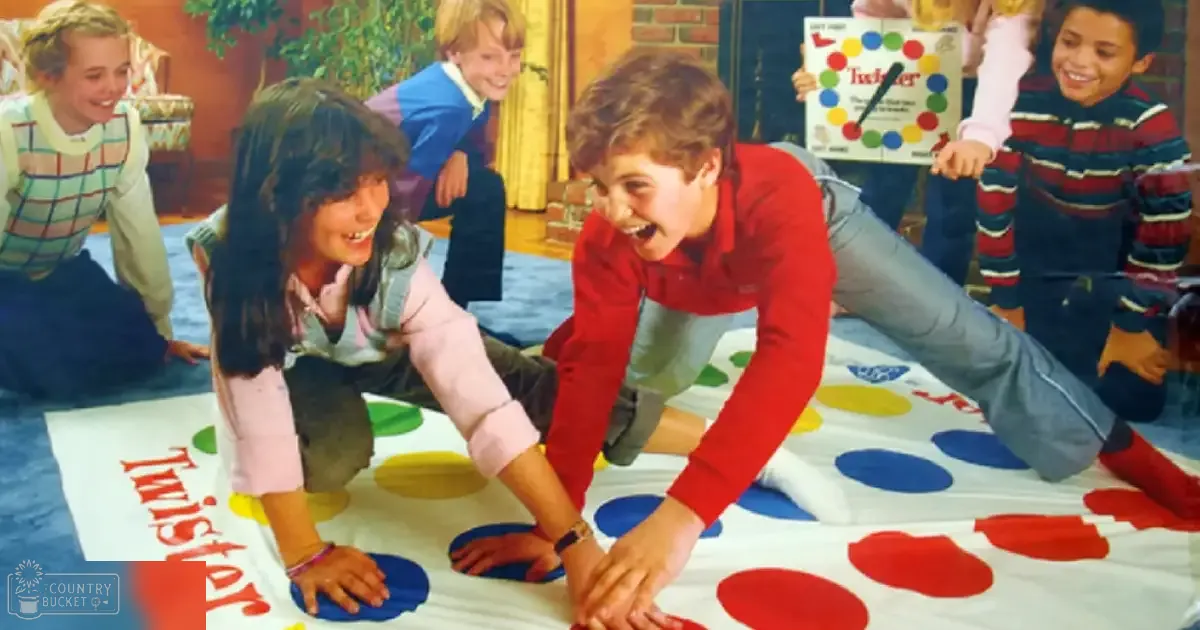 Children playing Twister on a blue mat indoors with natural light and brick wall background.