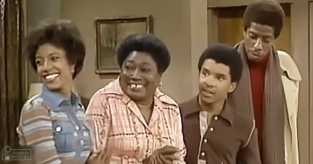 A family scene set in an indoor living room, with adults and children dressed in clothing typical of the 1970s era.