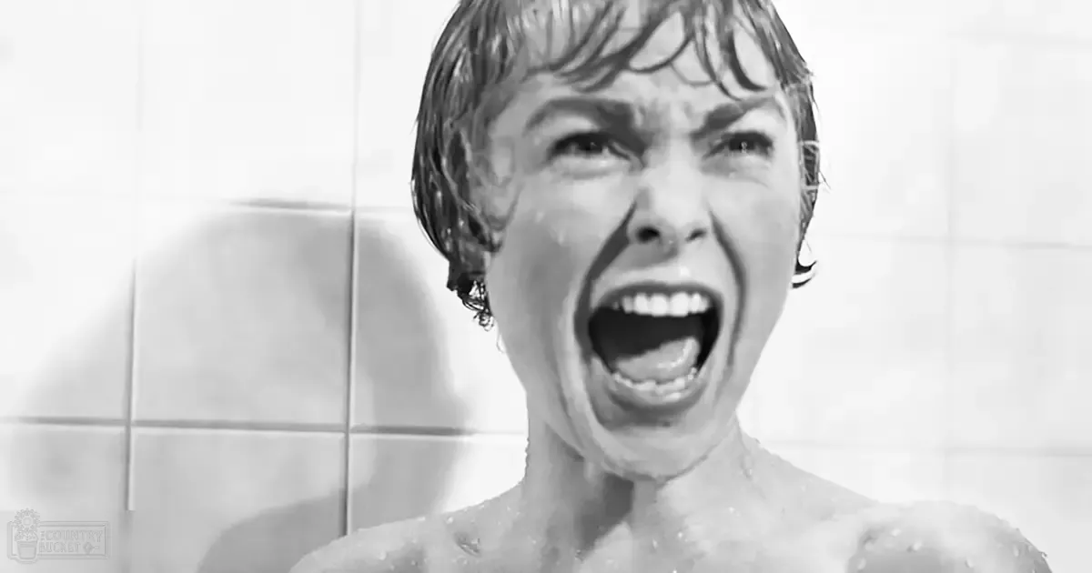 A young adult female with wet hair in a shower setting, daytime lighting, black and white photograph