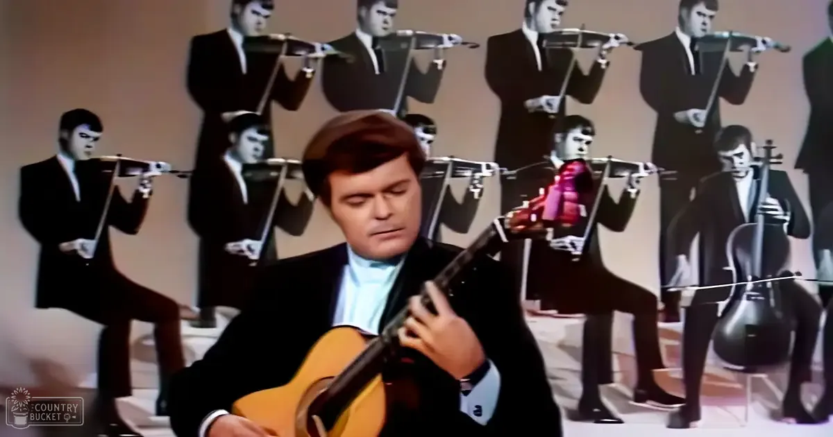 A musician playing guitar in front of a plain indoor backdrop with multiple images of violinists in dark suits and white shirts.