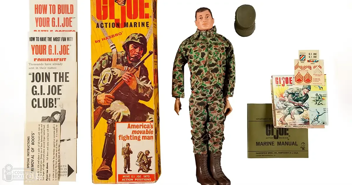 A G.I. Joe action figure dressed in camouflage with a helmet, displayed alongside its box labeled 'G.I. JOE ACTION MARINE' by HASBRO.