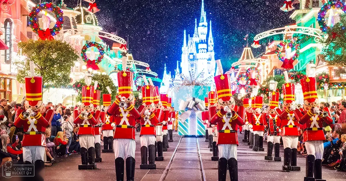 A festive Christmas parade at Disney World, Orlando during winter with snowfall; children in warm holiday attire and toy soldiers leading the procession.