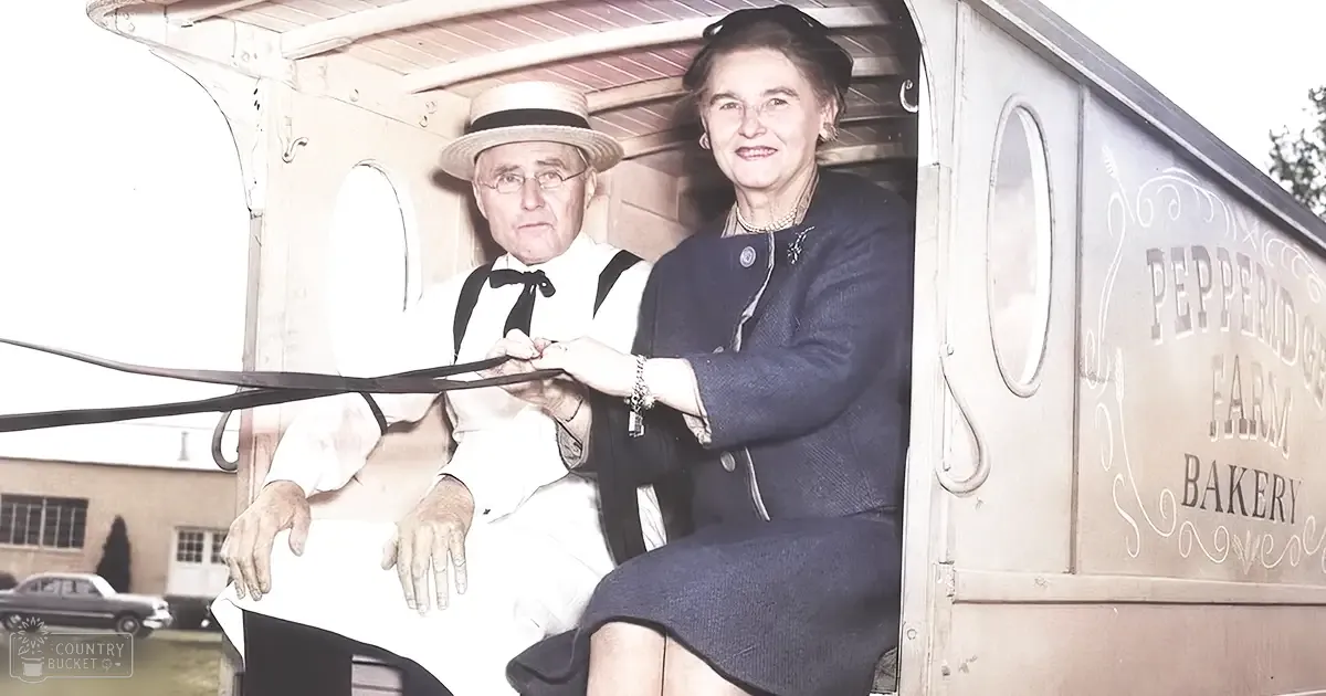 An older adult couple at a Pepperidge Farm Bakery ribbon-cutting ceremony in formal attire with a vintage car visible in the background.