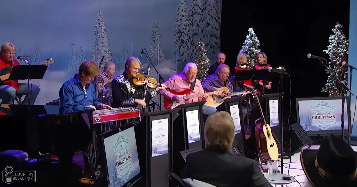 Musical performance during Christmas with festive decorations and snowy landscapes in the background.