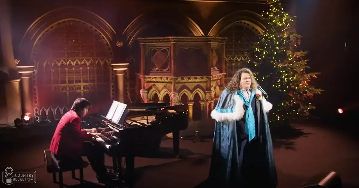 A Christmas performance in an ornate church or cathedral with performers in formal attire and a decorated Christmas tree, suggesting the holiday season.