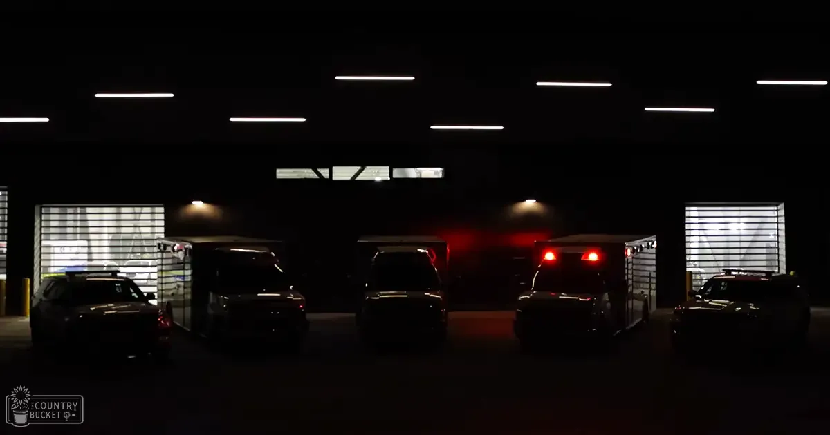 An underground parking garage at night with vehicles and artificial lighting