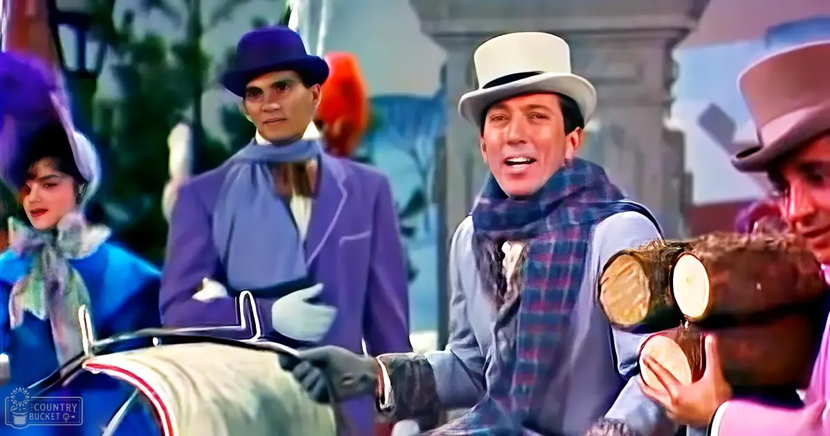 An adult male in a white top hat and scarf stands outdoors, next to classical architecture, surrounded by other individuals dressed in period attire.