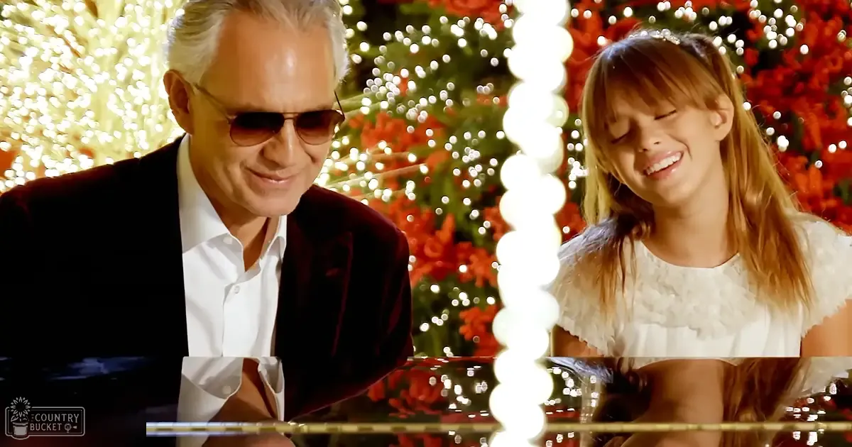 A middle-aged man and a young girl in festive Christmas attire, surrounded by holiday decorations indoors.