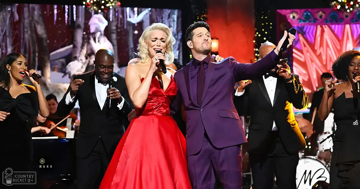 A performance scene at an event, possibly a concert or awards show with performers on stage. Festive decorations and holiday-themed elements are visible.