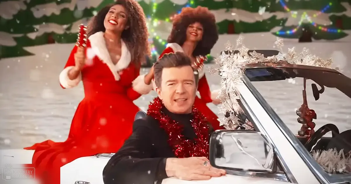 A middle-aged adult male driving a white convertible with silver snowflake decorations, accompanied by two young female Santas dressed in festive red and white attire, outdoors on a snowy Christmas day.