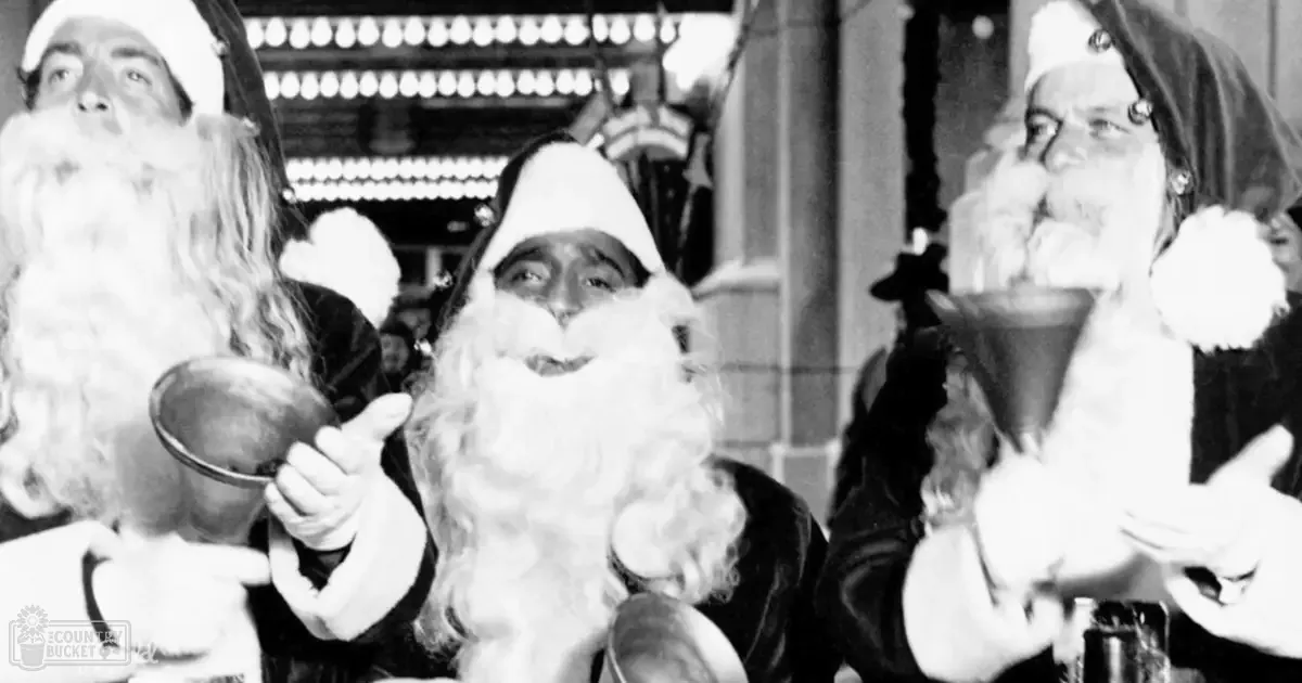 A festive indoor market or fair with individuals dressed as Santa Claus under natural daylight.