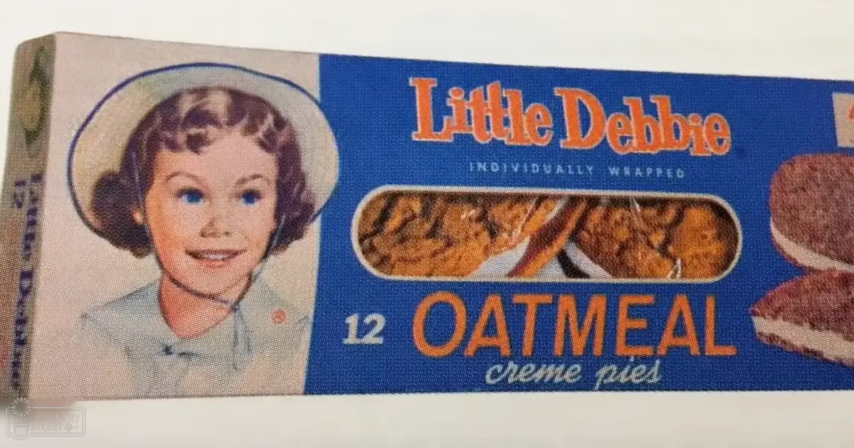 An advertisement for Little Debbie Oatmeal Creme Pies, with a close-up of the product box with text and images of the pies against a plain white background.